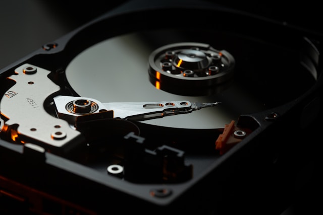 failed-hard-drive-data-at-risk Open hard drive with exposed platters and read/write arm